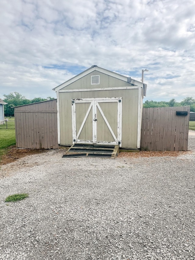 view of shed with fence