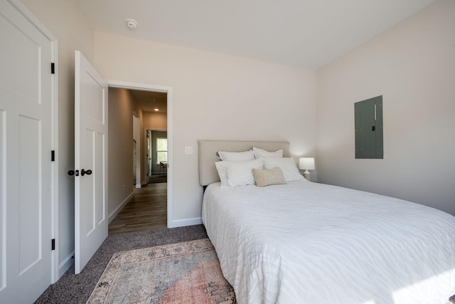 carpeted bedroom with baseboards and electric panel