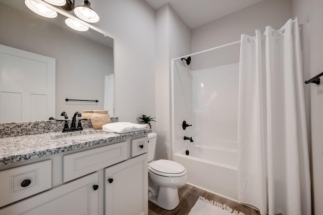 full bathroom featuring vanity, shower / bath combo with shower curtain, toilet, and wood finished floors