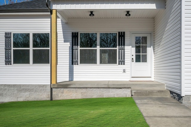 doorway to property featuring roof with shingles