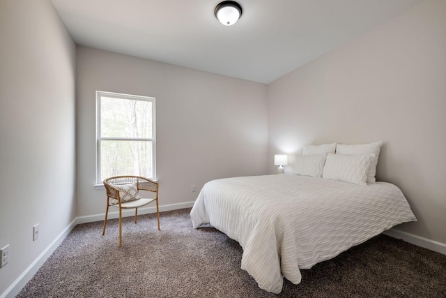 carpeted bedroom featuring baseboards