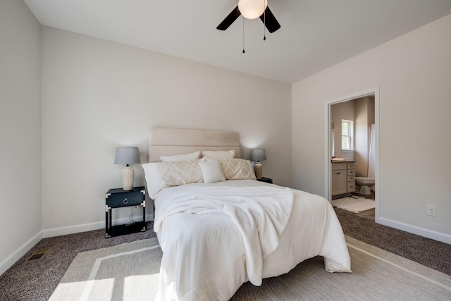 carpeted bedroom featuring baseboards, a ceiling fan, and ensuite bath