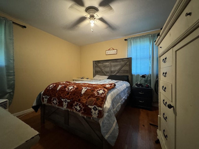 bedroom featuring baseboards, ceiling fan, and wood finished floors