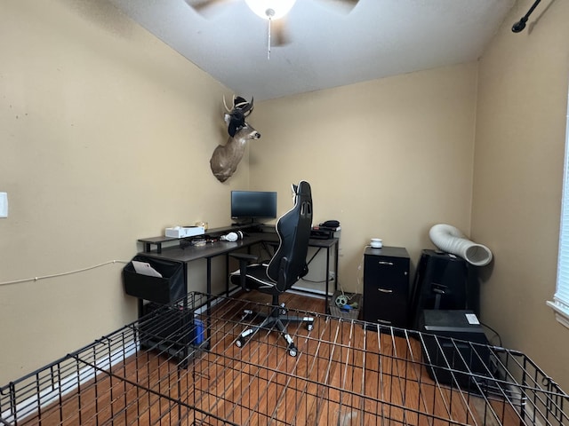 office area with ceiling fan and wood finished floors