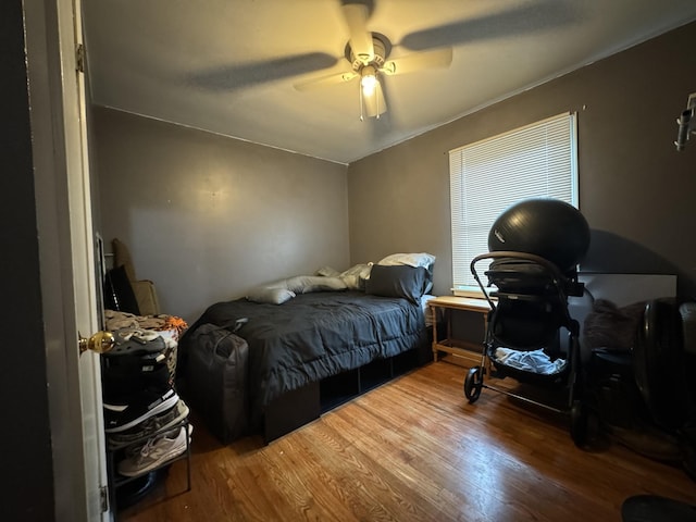 bedroom with ceiling fan and wood finished floors