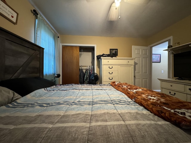 bedroom with ceiling fan and a closet