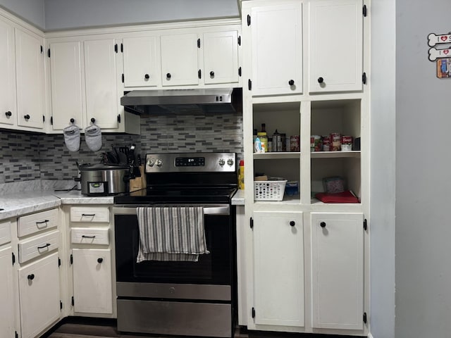 kitchen with light countertops, white cabinetry, under cabinet range hood, stainless steel electric stove, and tasteful backsplash