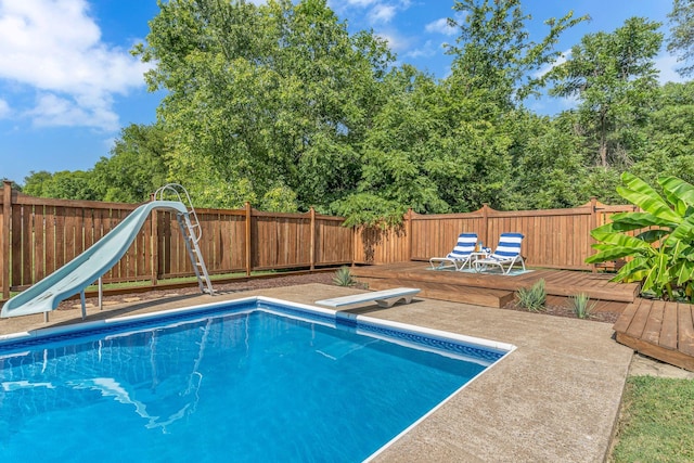4043 Marydale Dr, Nashville, TN 37207 - view of swimming pool with a fenced backyard, a diving board, a water slide, and a wooden deck