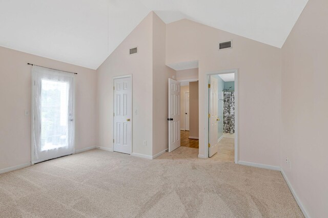 517 Wildwood Dr, Smyrna, TN 37167 - unfurnished bedroom featuring visible vents, high vaulted ceiling, and light colored carpet