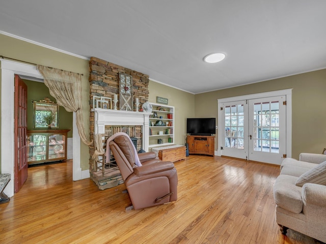 609 W Main St, Waverly, TN 37185 - living area with french doors, crown molding, a large fireplace, baseboards, and light wood finished floors