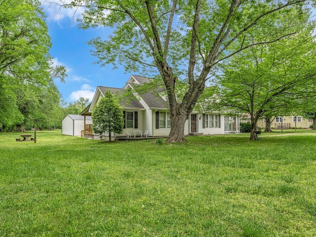 609 W Main St, Waverly, TN 37185 - view of front facade with an outdoor structure, a shed, and a front yard