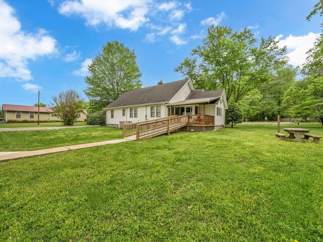 609 W Main St, Waverly, TN 37185 - view of front facade with a chimney, a front yard, and a deck