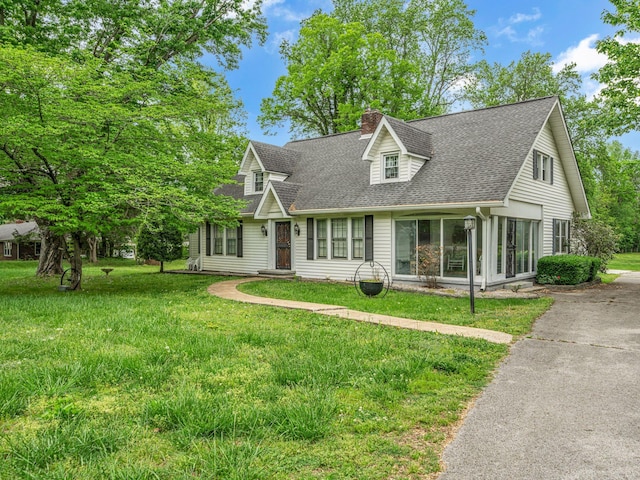 609 W Main St, Waverly, TN 37185 - cape cod house with a chimney, roof with shingles, and a front lawn