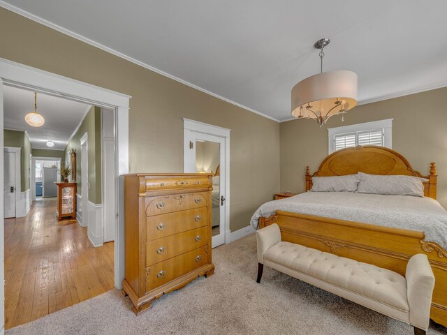 609 W Main St, Waverly, TN 37185 - bedroom featuring crown molding, baseboards, a chandelier, and light wood-style floors