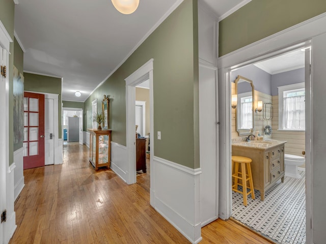 609 W Main St, Waverly, TN 37185 - hallway featuring crown molding, light wood-style flooring, and a sink