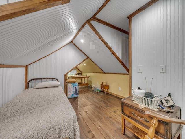 609 W Main St, Waverly, TN 37185 - bedroom featuring wood walls, vaulted ceiling, and hardwood / wood-style flooring