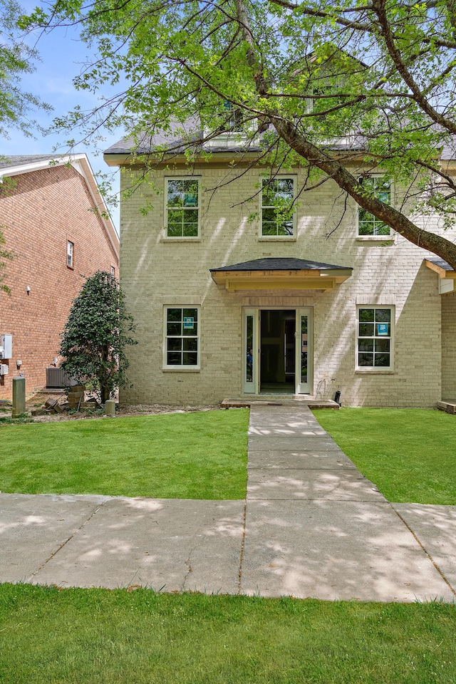 2145 Cason Ln, Murfreesboro, TN 37128 - view of front of house featuring central air condition unit, brick siding, and a front lawn
