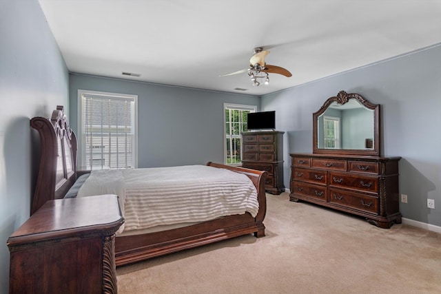 carpeted bedroom with ceiling fan and visible vents