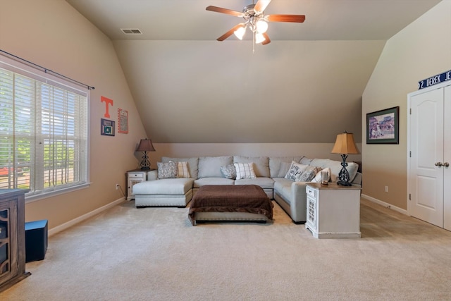 living area with baseboards, a ceiling fan, carpet, and lofted ceiling