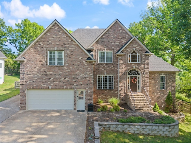 traditional-style home with a garage, concrete driveway, and brick siding