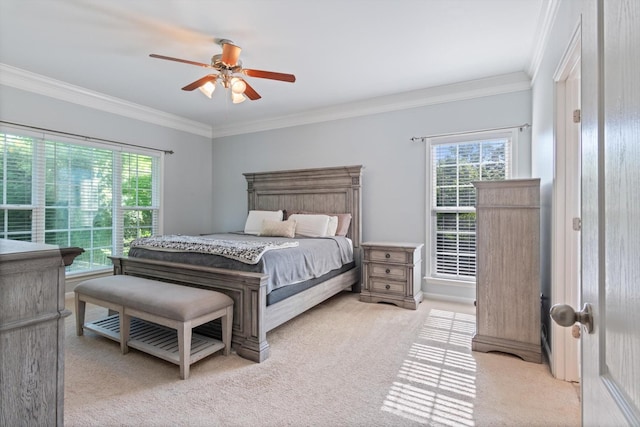 bedroom with light colored carpet, ornamental molding, ceiling fan, and multiple windows