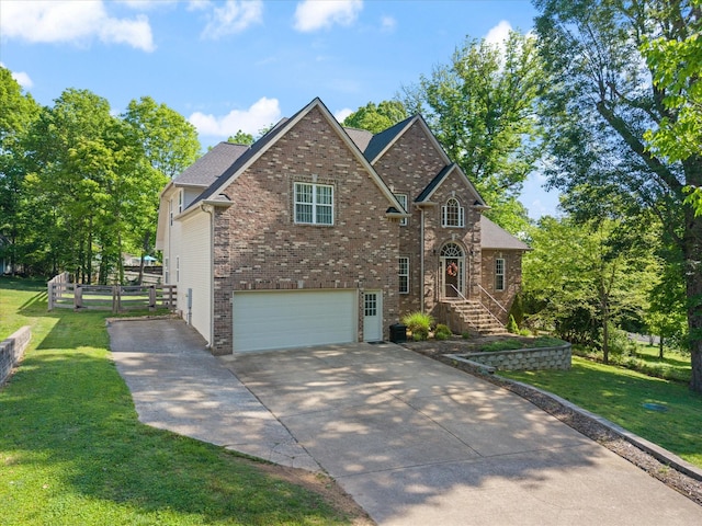 traditional home with brick siding, fence, a front lawn, concrete driveway, and an attached garage