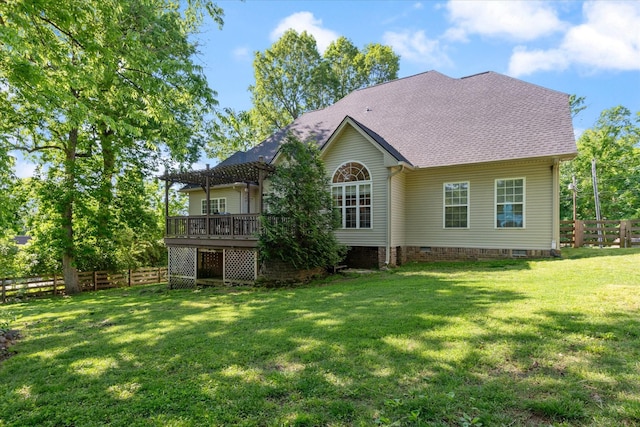 back of house with crawl space, a lawn, a deck, fence, and a pergola