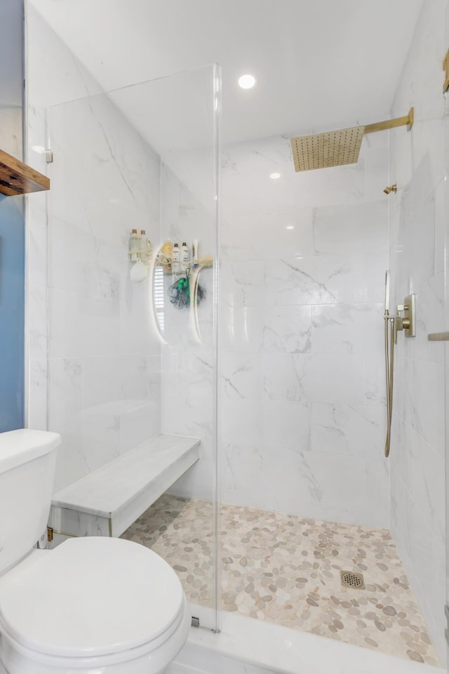 bathroom with toilet, recessed lighting, and a marble finish shower