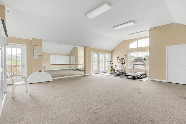 workout room with french doors, carpet floors, baseboards, and vaulted ceiling