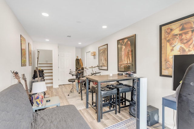 interior space with light wood-type flooring, recessed lighting, visible vents, and stairway