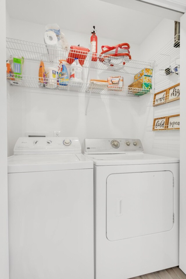 clothes washing area with laundry area and washing machine and clothes dryer