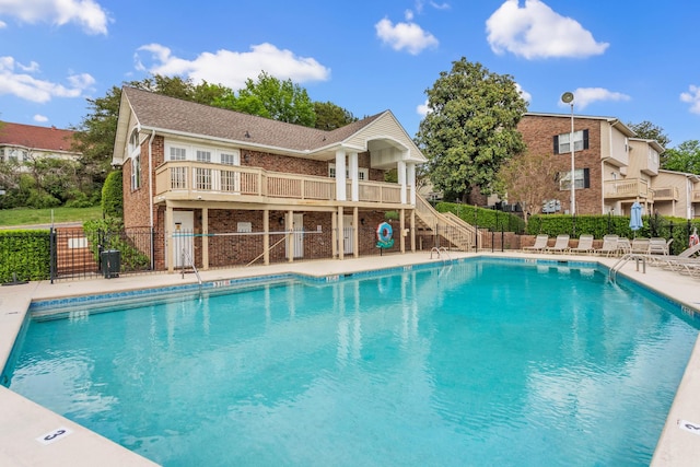 pool featuring fence and stairs