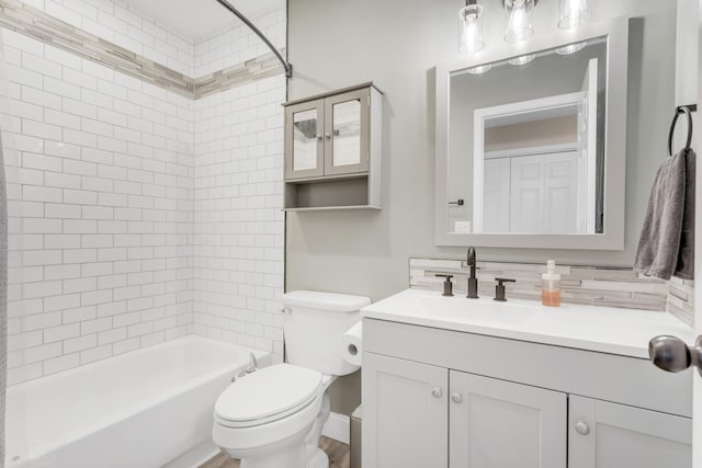 full bathroom featuring shower / bath combination, vanity, decorative backsplash, and toilet
