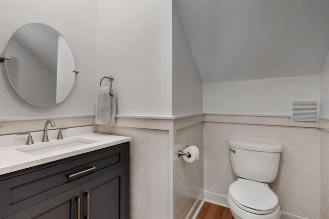 1012 Carrs Creek Blvd, Greenbrier, TN 37073 - bathroom featuring visible vents, vanity, a wainscoted wall, toilet, and lofted ceiling