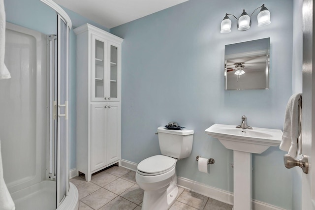 1012 Carrs Creek Blvd, Greenbrier, TN 37073 - bathroom with ceiling fan, tile patterned flooring, a stall shower, baseboards, and toilet