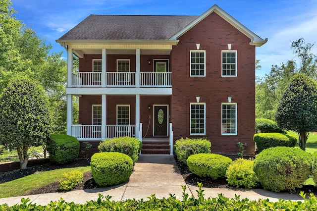 1012 Carrs Creek Blvd, Greenbrier, TN 37073 - view of front of house with a porch, brick siding, and a balcony