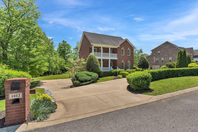 1012 Carrs Creek Blvd, Greenbrier, TN 37073 - view of front of home featuring curved driveway, a balcony, and a front yard