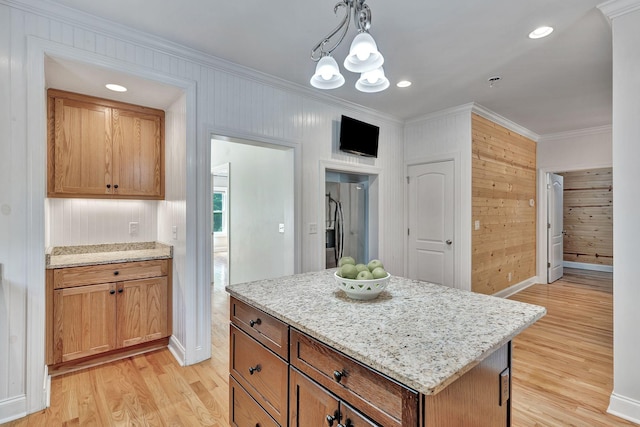 1012 Carrs Creek Blvd, Greenbrier, TN 37073 - kitchen with light stone counters, baseboards, ornamental molding, and light wood-style flooring
