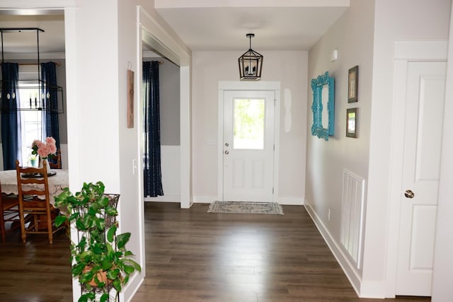 entryway featuring baseboards, visible vents, and dark wood-type flooring