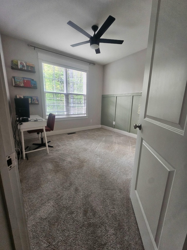 office space featuring visible vents, a ceiling fan, and carpet