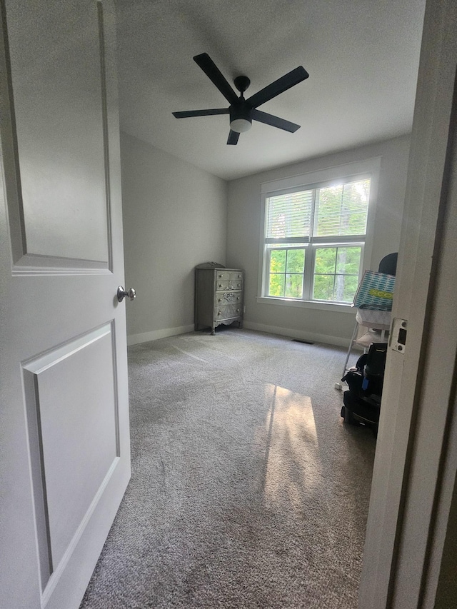 bedroom featuring a ceiling fan, baseboards, and carpet