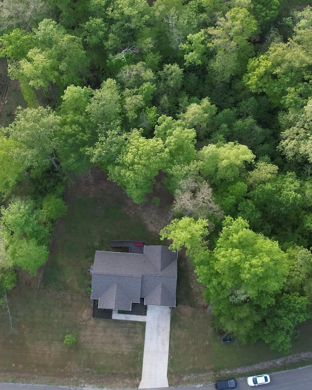drone / aerial view featuring a wooded view