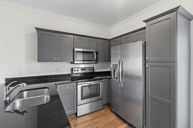 4325 Ashland City Hwy Unit 8, Nashville, TN 37218 - kitchen with decorative backsplash, crown molding, appliances with stainless steel finishes, a sink, and dark stone counters