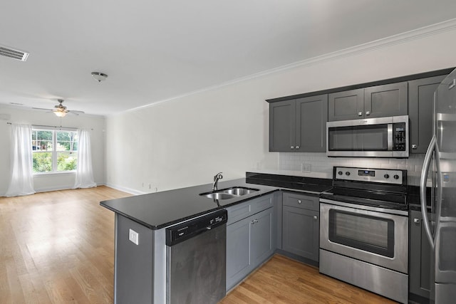 4325 Ashland City Hwy Unit 8, Nashville, TN 37218 - kitchen with visible vents, a peninsula, open floor plan, a sink, and appliances with stainless steel finishes