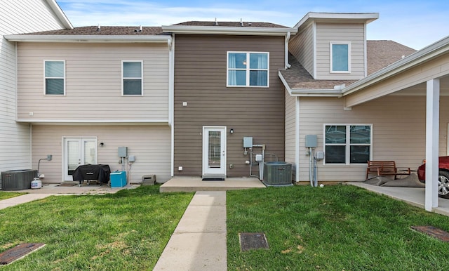 4325 Ashland City Hwy Unit 8, Nashville, TN 37218 - rear view of house with a lawn, a patio, cooling unit, and roof with shingles