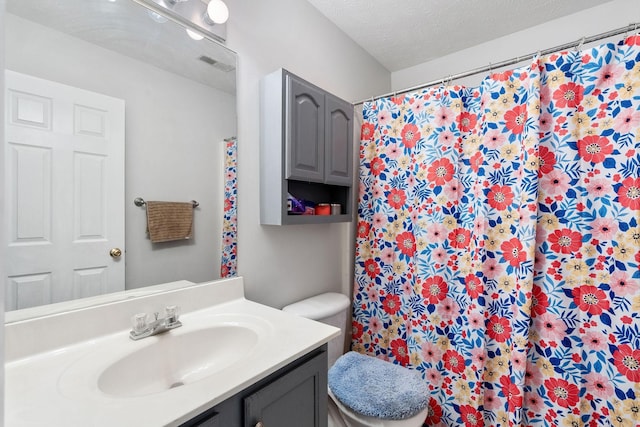 full bathroom with vanity, a shower with curtain, toilet, and visible vents