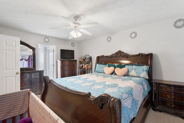 bedroom with carpet flooring, a ceiling fan, and ensuite bath