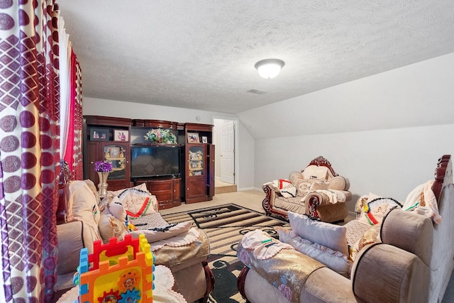 carpeted living area with a textured ceiling and lofted ceiling
