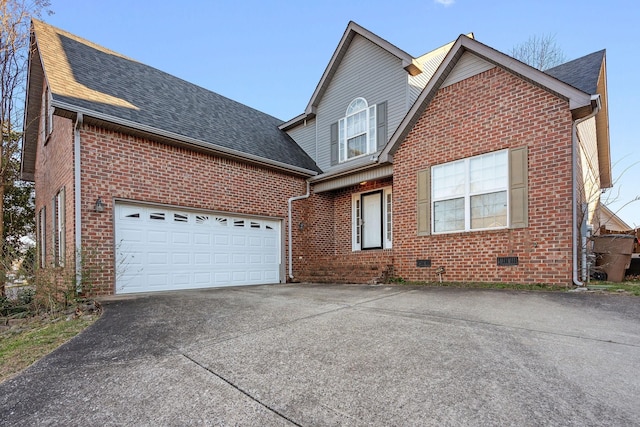 traditional-style house with brick siding, a shingled roof, and concrete driveway