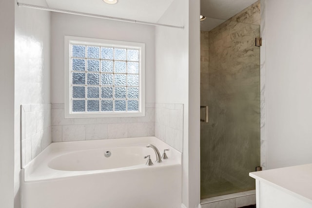 bathroom with vanity, a shower stall, and a bath